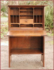 Desk open, view of pigeon holes, drawer and recessed areas for pencils and inkwells.